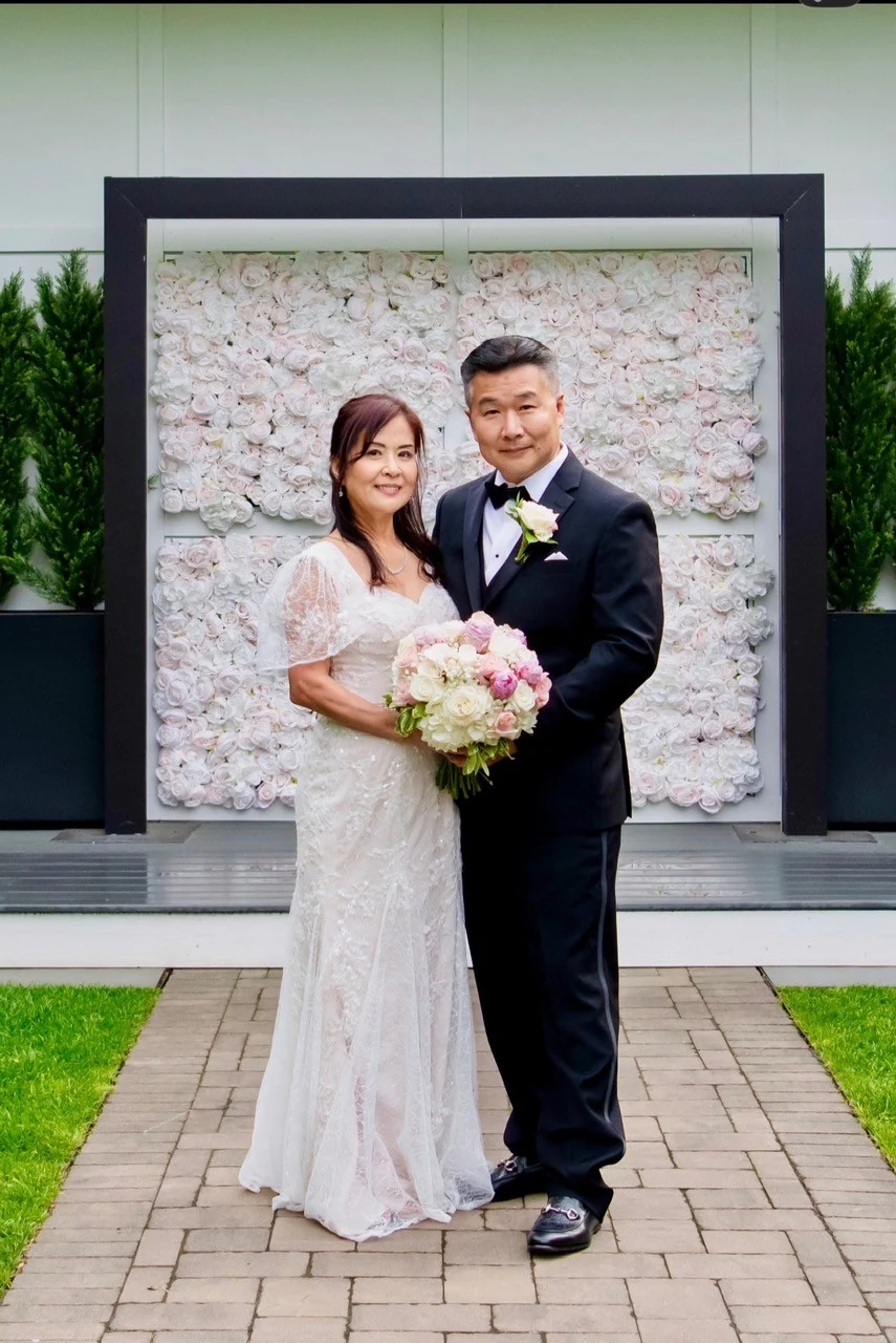 Allemang wedding bride and groom at the floral wall by Domenic Graziano Flowers