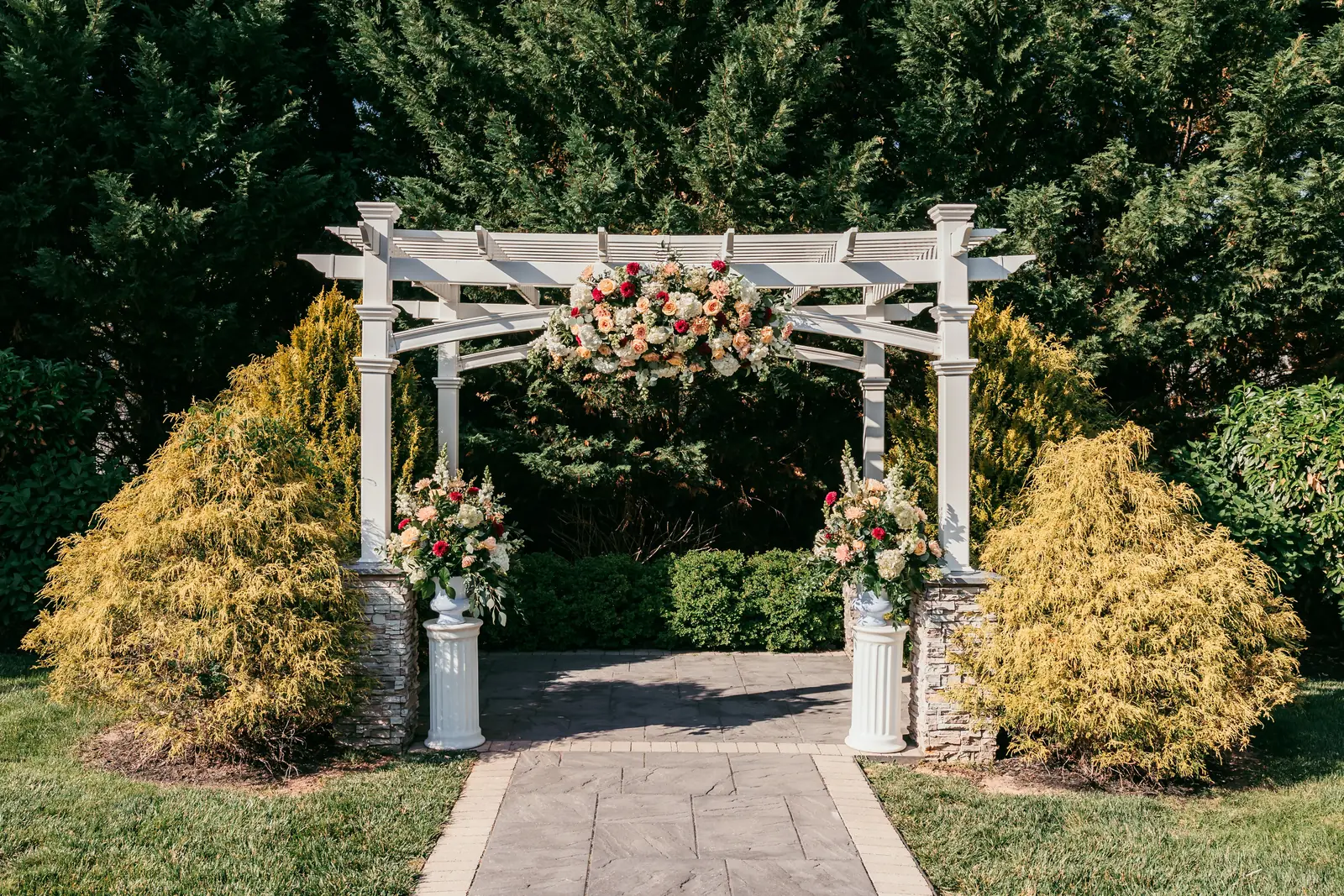 Emily and Rocco wedding ceremony pergola and pedestal arrangements at The Warrington by Domenic Graziano Flowers